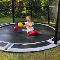 Child on 10ft in-ground trampoline with half net Thumbnail