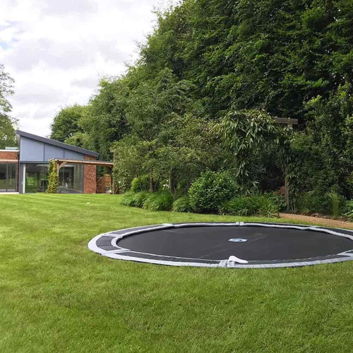 Large 12ft in-ground trampoline in lawn